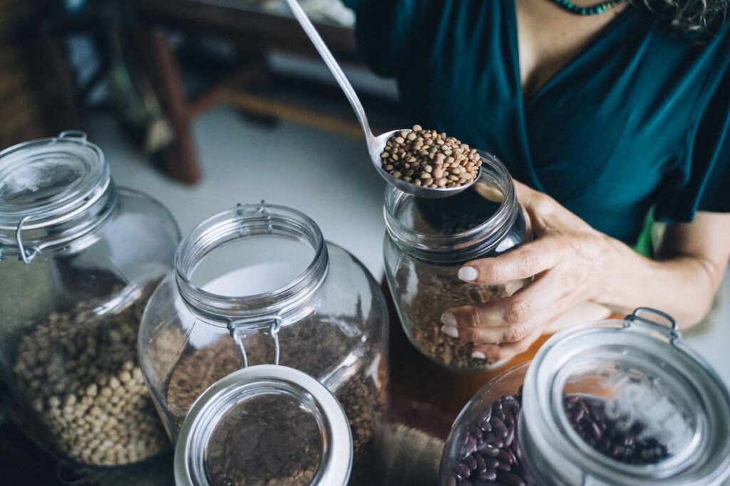 Refilling dry goods - lentils being spooned into jar